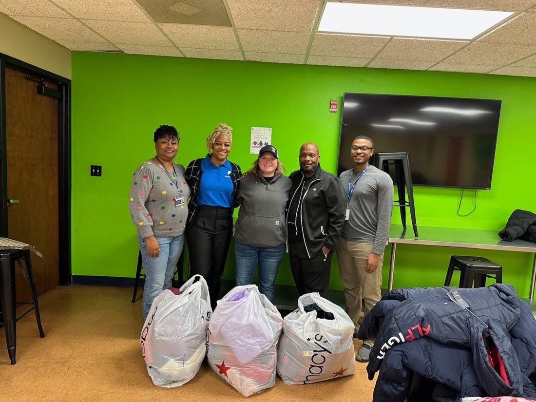 Members with bags of donated coats and clothing